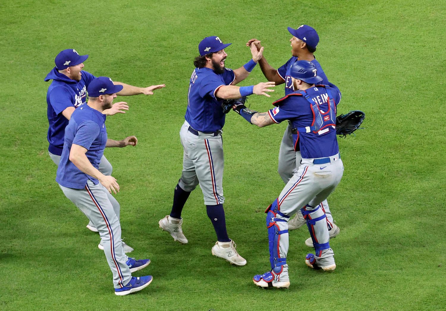 Oct 23, 2023; Houston, Texas, USA; Texas Rangers catcher Austin Hedges (11), pitcher Jose Leclerc (25) and catcher Jonah Heim (28) celebrate after winning game seven in the ALCS against the Houston Astros for the 2023 MLB playoffs at Minute Maid Park. Mandatory Credit: Troy Taormina-USA TODAY Sports